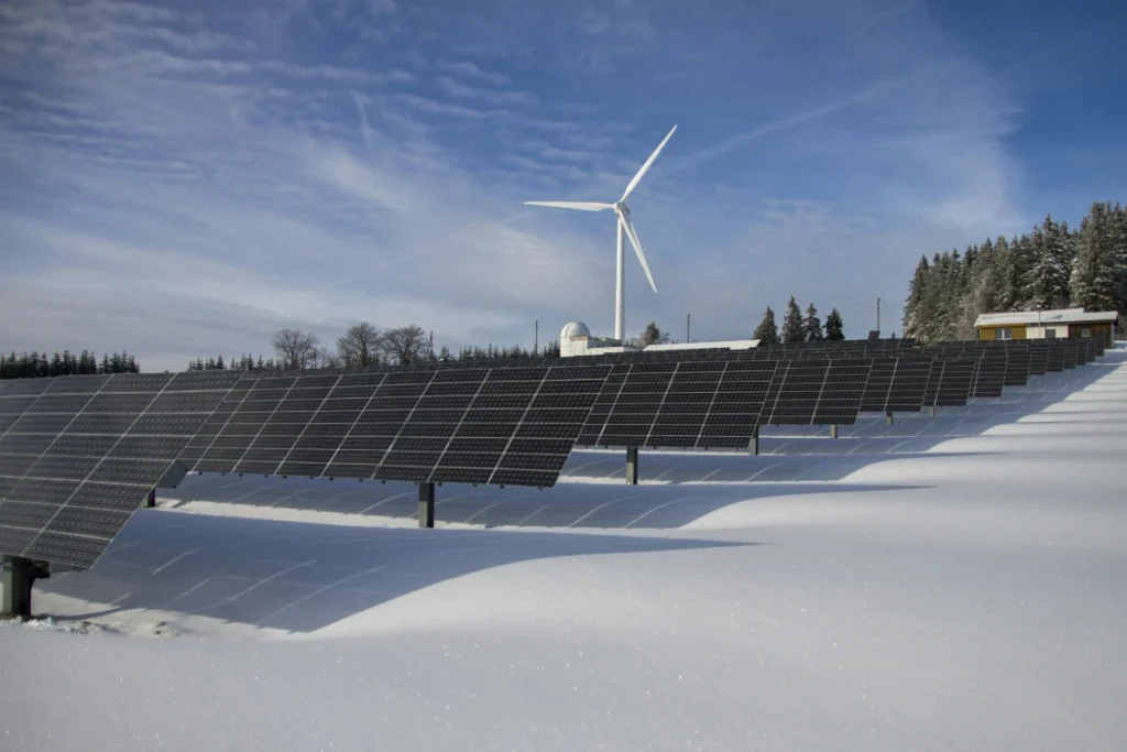 a hybrid alternative energy system with wind turbine and solar panels. taken during the winter with snow on the ground